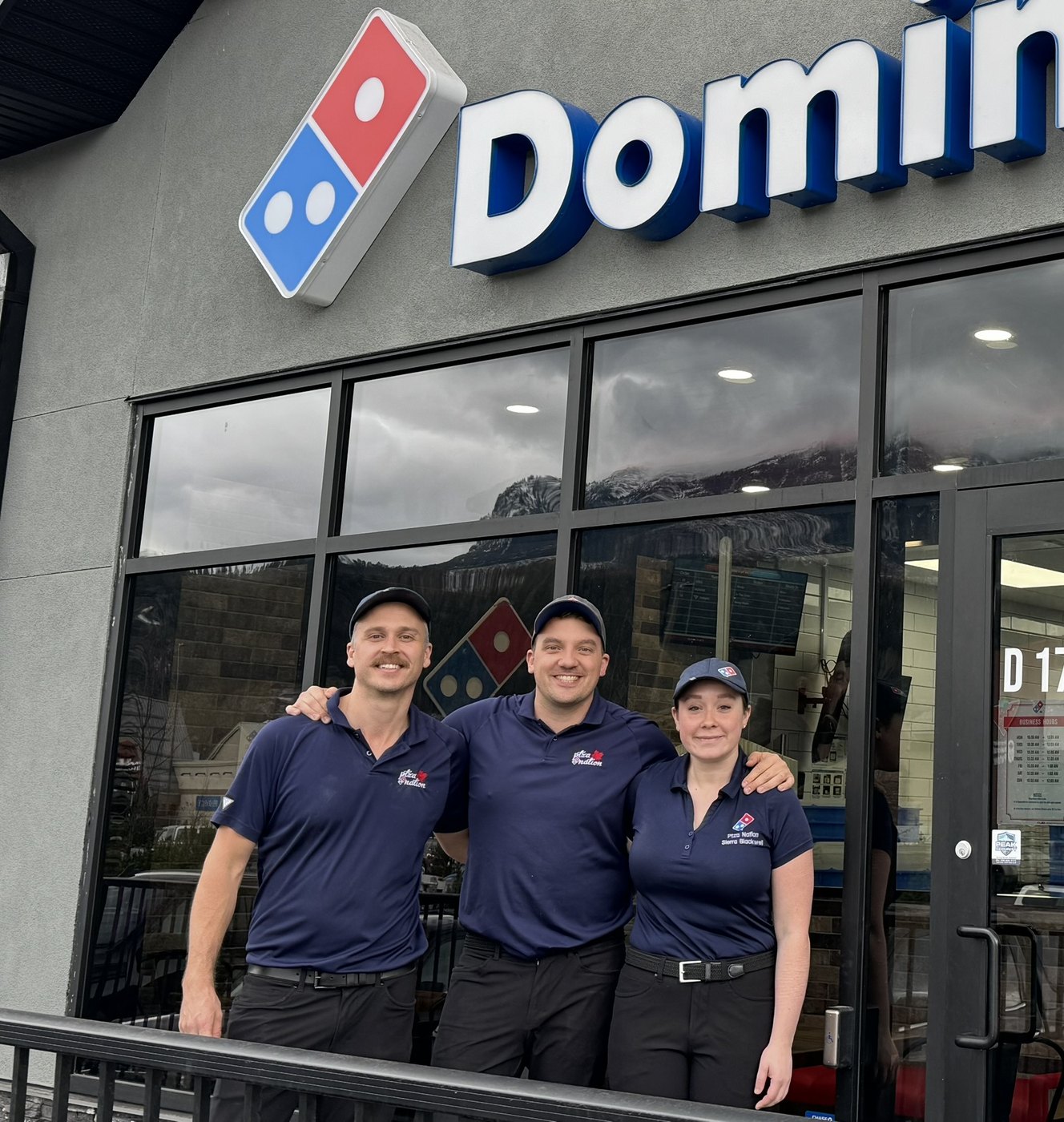 Daniel Tripp, Louis Nelson and Sierra Blackwell outside a Domino’s store
